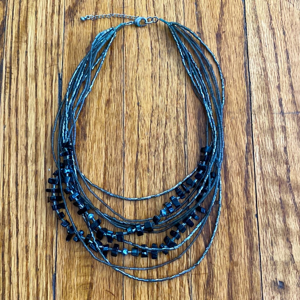 Silver/gray and black beaded 10 strand tiered necklace.